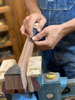 Carving a decorative relief around the 5th string tuner